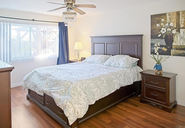 bedroom with ceiling fan and dark hardwood / wood-style flooring