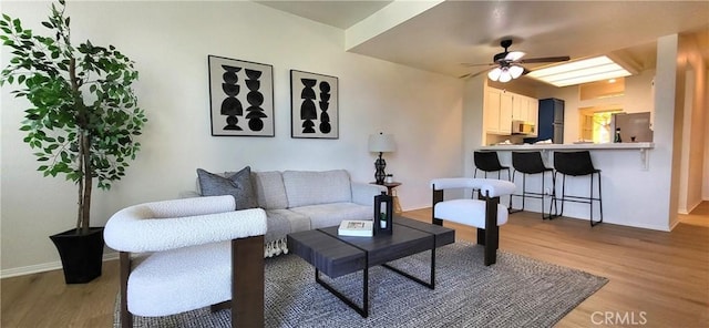 living room featuring light hardwood / wood-style floors and ceiling fan