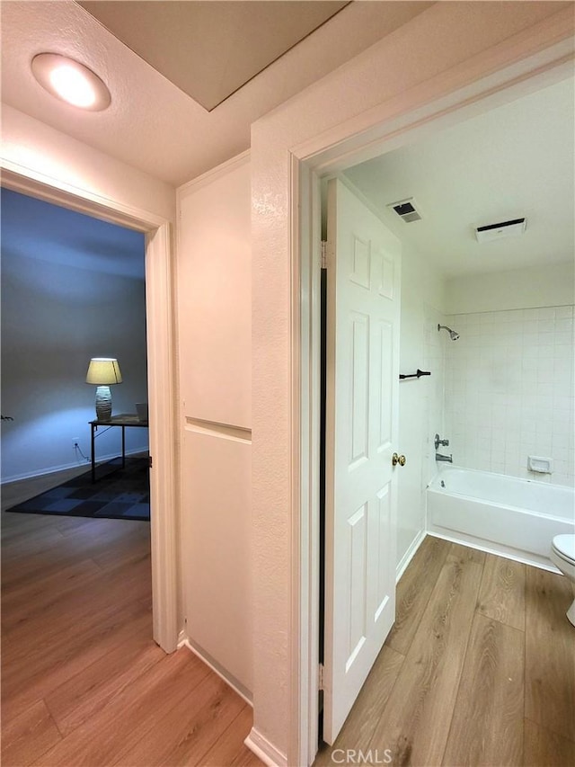 corridor featuring light hardwood / wood-style floors