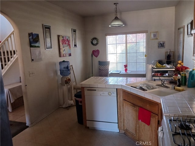 kitchen featuring stainless steel range, dishwasher, tile countertops, and hanging light fixtures