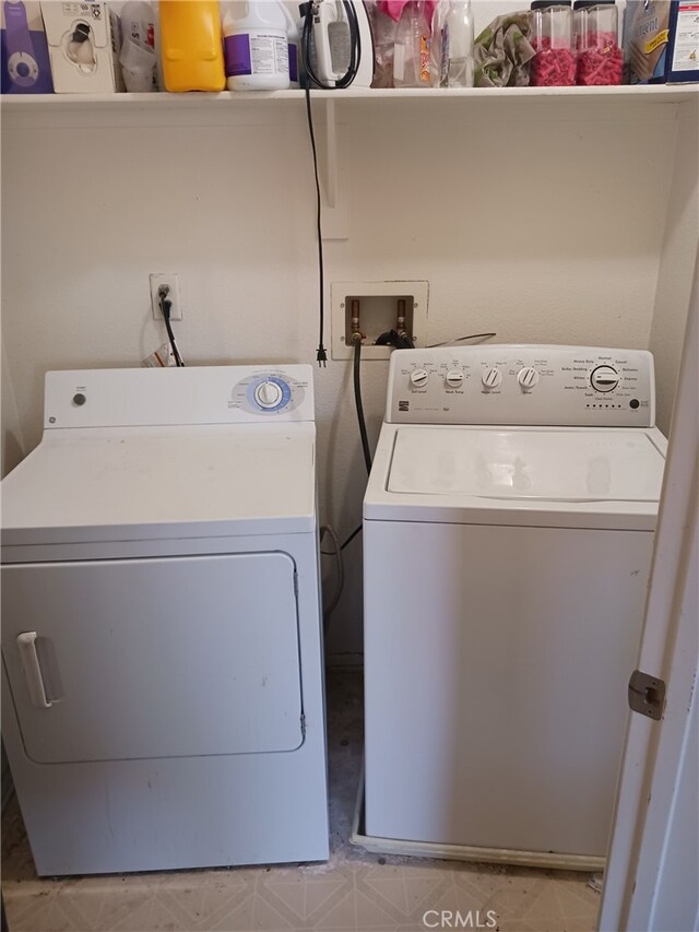 clothes washing area with washing machine and clothes dryer