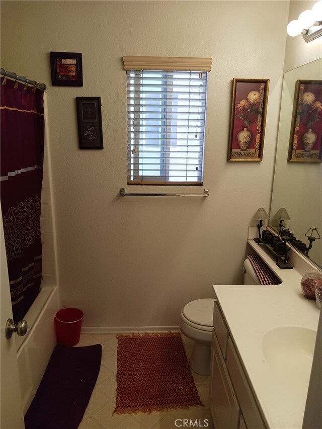 full bathroom featuring shower / tub combo with curtain, tile patterned floors, vanity, and toilet