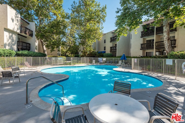 view of swimming pool with a patio area