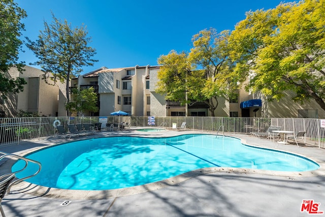 view of swimming pool with a patio area