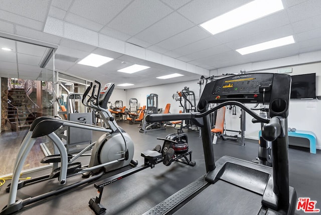 exercise room with a drop ceiling