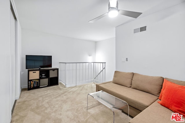 living room with ceiling fan and light carpet