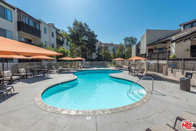 view of swimming pool featuring a patio area