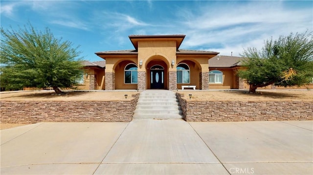 mediterranean / spanish house with stucco siding