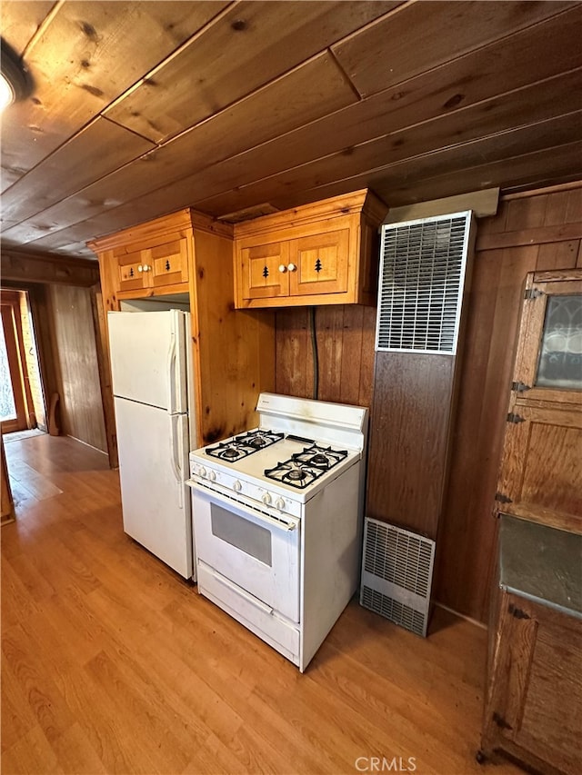 kitchen featuring wooden ceiling, white appliances, wooden walls, and light hardwood / wood-style flooring