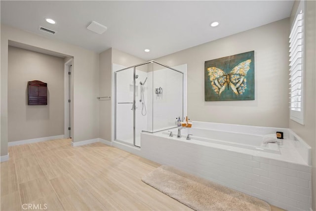 bathroom featuring hardwood / wood-style flooring and shower with separate bathtub