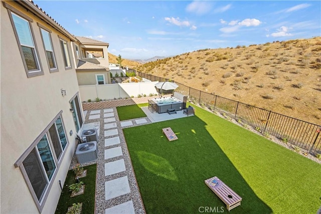 view of yard with an outdoor living space, cooling unit, and a patio