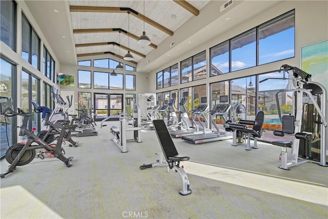 workout area featuring wood ceiling and high vaulted ceiling