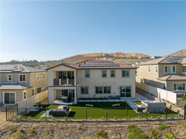 rear view of property featuring a mountain view and a patio