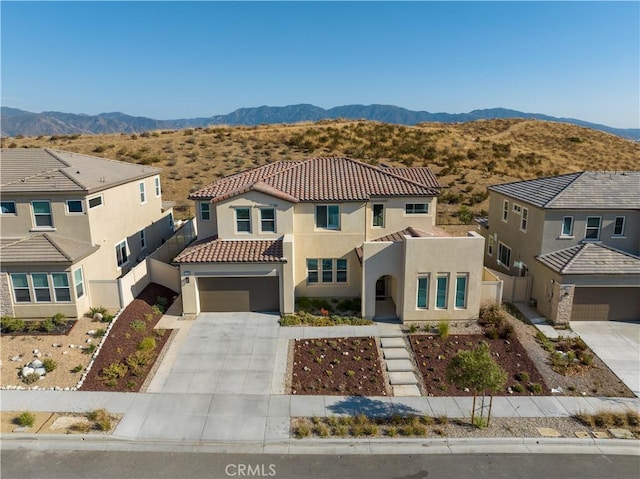 view of front of home with a garage and a mountain view