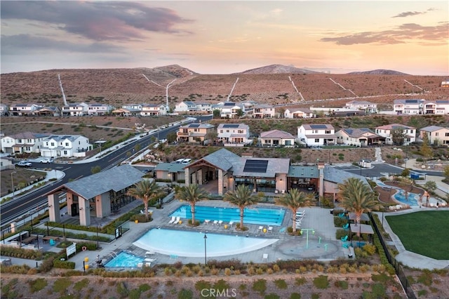 aerial view at dusk featuring a mountain view