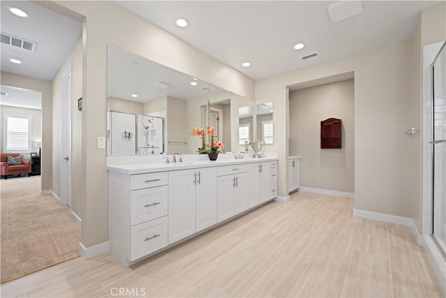 bathroom featuring an enclosed shower and vanity