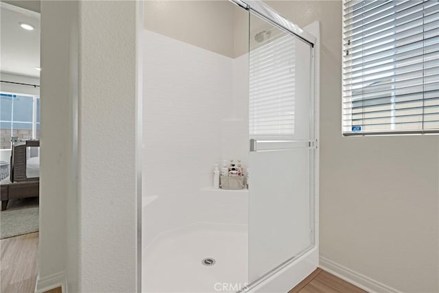 bathroom featuring hardwood / wood-style flooring and an enclosed shower