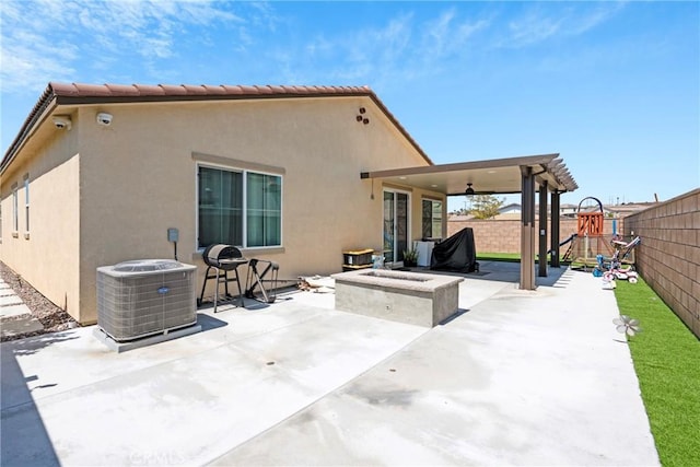 rear view of property with central AC, ceiling fan, and a patio