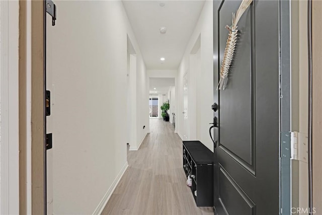 hall with light hardwood / wood-style floors