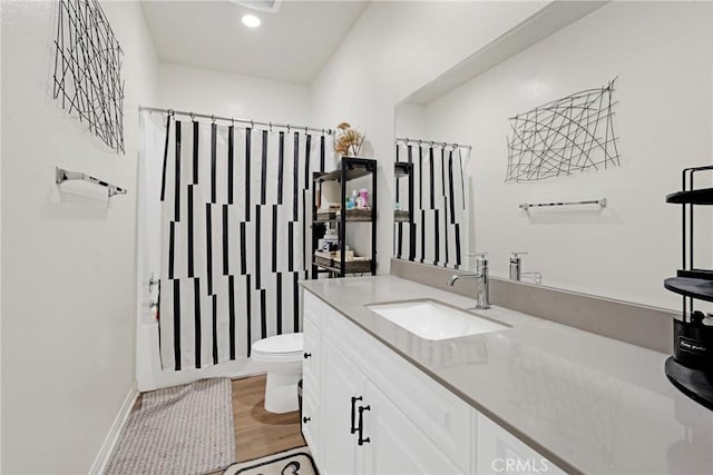 full bathroom featuring shower / bath combination with curtain, vanity, toilet, and hardwood / wood-style floors