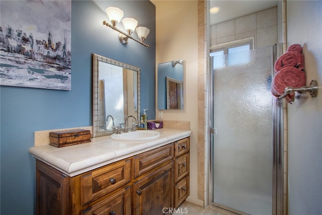 bathroom featuring an enclosed shower and vanity