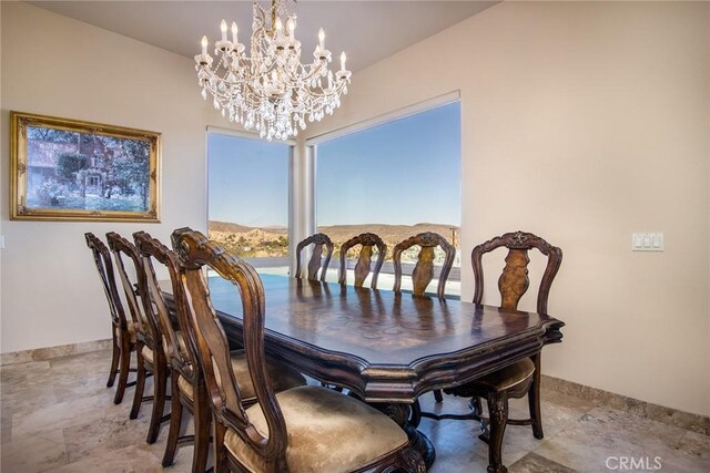 56245 Cobalt Rd, Yucca Valley, CA 92284 - dining space featuring a chandelier, baseboards, and stone finish floor