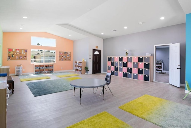 rec room with light hardwood / wood-style flooring and lofted ceiling