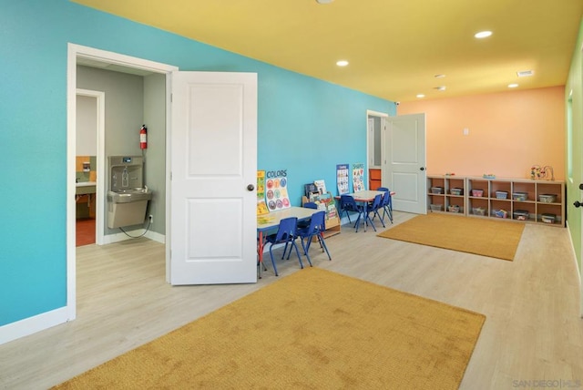 playroom with wood-type flooring