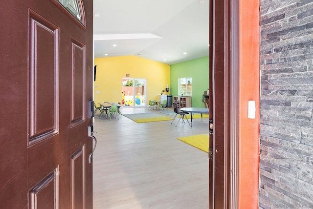 entrance foyer featuring lofted ceiling and light hardwood / wood-style flooring