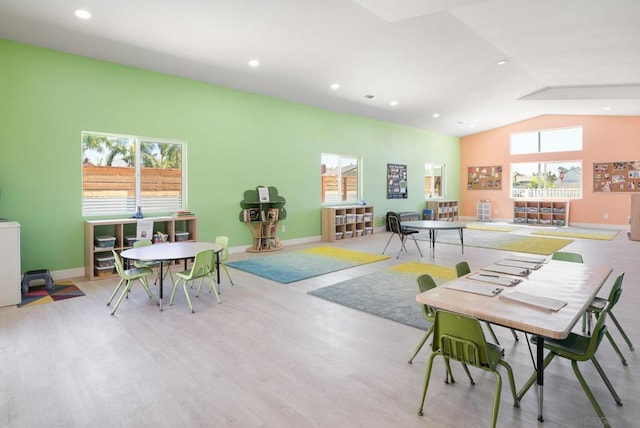 rec room featuring vaulted ceiling and light hardwood / wood-style floors