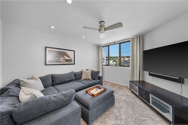living room featuring ceiling fan, recessed lighting, baseboards, and light carpet