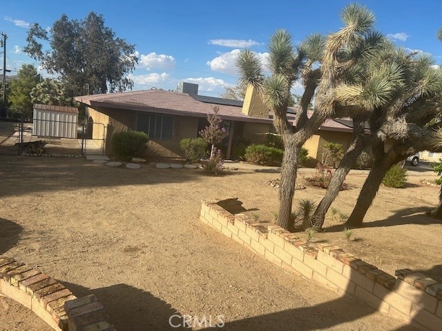 view of front of house featuring a storage shed