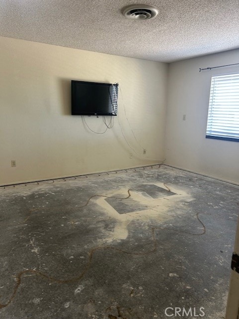 spare room featuring a textured ceiling