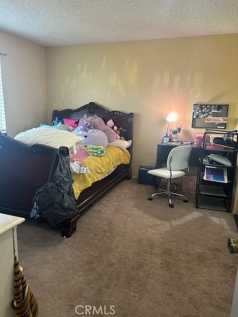 carpeted bedroom featuring a textured ceiling