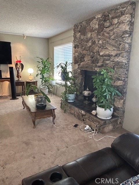 living room with carpet, a textured ceiling, and a fireplace