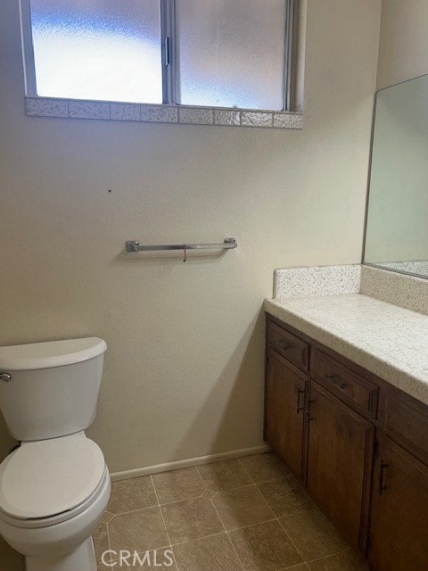 bathroom featuring vanity, toilet, and tile patterned floors