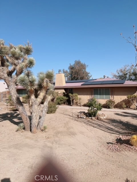 view of front of property with solar panels