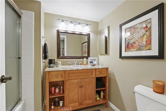 full bathroom featuring vanity, toilet, and enclosed tub / shower combo