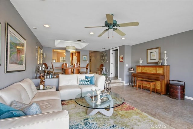 tiled living room featuring ceiling fan