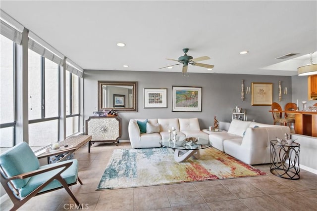 tiled living room with ceiling fan