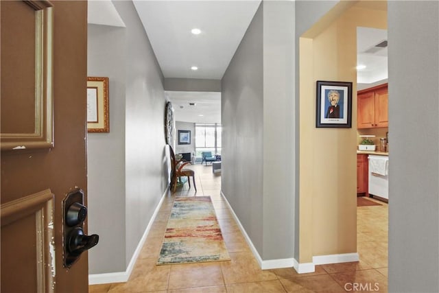 hall featuring light tile patterned floors