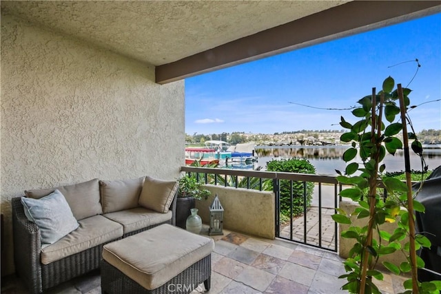 balcony featuring a water view