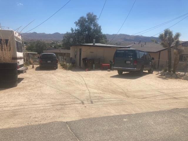 view of property exterior with a mountain view