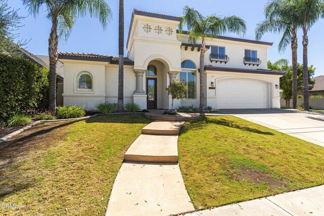 mediterranean / spanish-style house featuring a front lawn and a garage