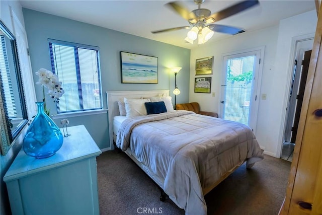 carpeted bedroom featuring access to outside, multiple windows, and ceiling fan