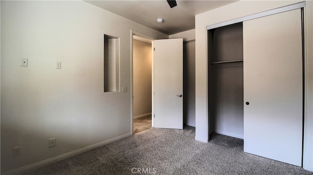 unfurnished bedroom featuring a closet, light colored carpet, and ceiling fan