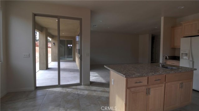 56925 Hidden Gold Ct, Yucca Valley, CA 92284 - kitchen featuring white fridge with ice dispenser, stone counters, light brown cabinets, an island with sink, and recessed lighting
