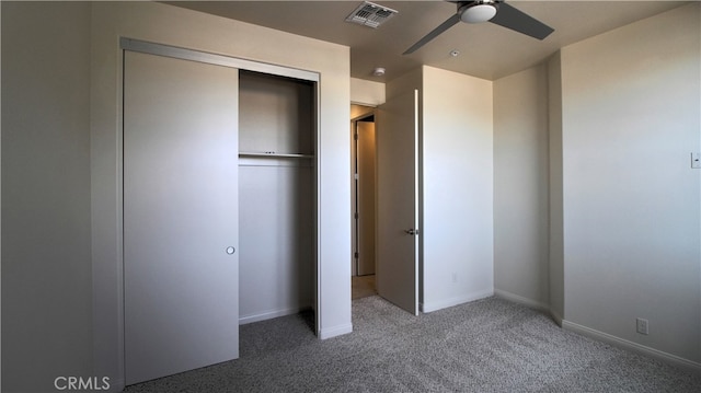 unfurnished bedroom with ceiling fan, a closet, and carpet flooring