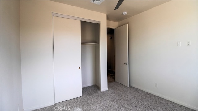 unfurnished bedroom featuring carpet, ceiling fan, and a closet