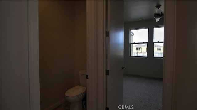 bathroom with ceiling fan and toilet